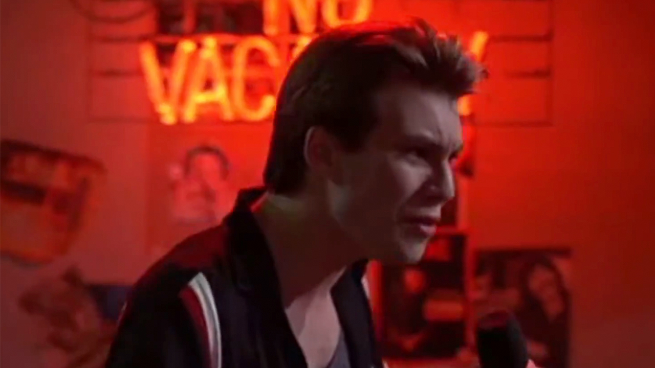 Christian Slater looking upset, bathed in red light in Pump Up The Volume