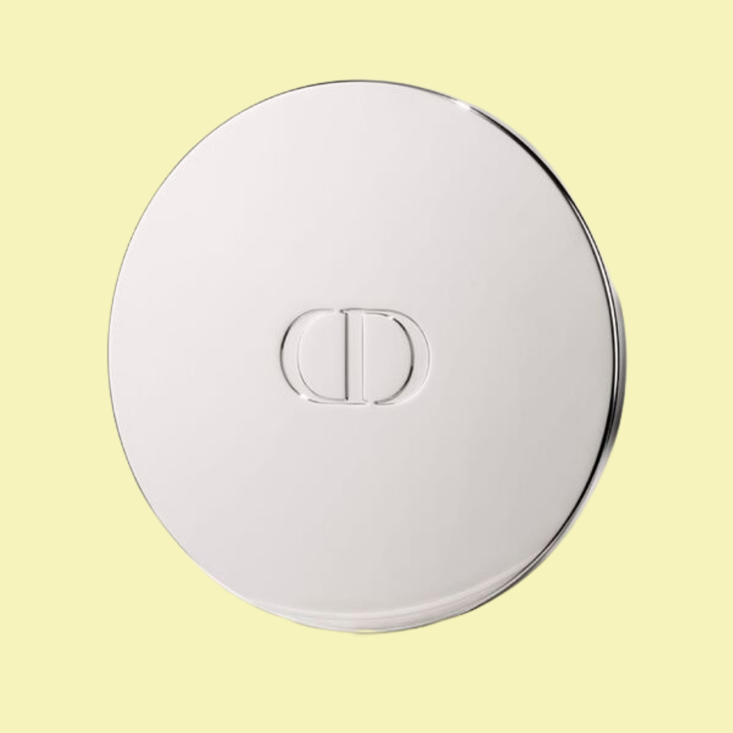 A silver candle cover with a Christian Dior embossed logo