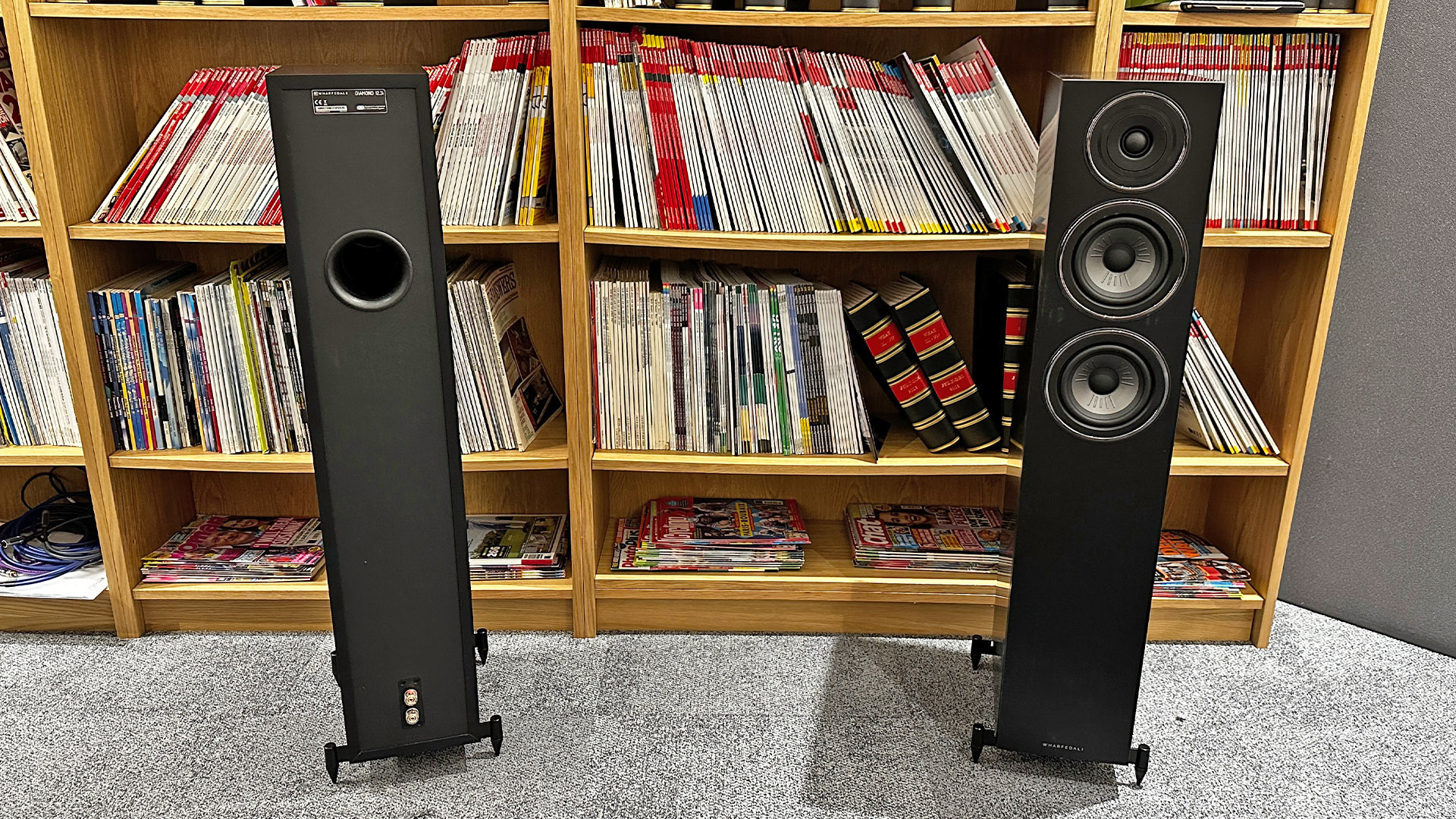 Wharfedale Diamond 12.3i floorstanding speakers on grey carpet in front of bookcase