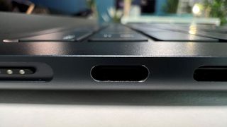 An image of the USB-C ports on the left side of a Midnight MacBook Air M2, showing obvious scratching around the edge of the port after only a few days of use.