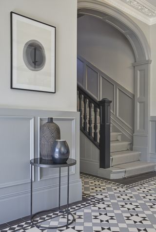 Hallway and staircase with runner with grey walls and grey painted staircase