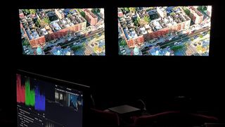 two LG OLED TVs in dark room being used for movie post production
