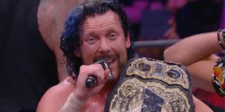 Kenny Omega celebrating his AEW Championship victory at AEW All Out 2021