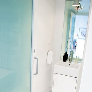 bathroom with mirror and white door