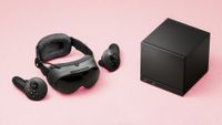 Valve Steam Frame VR headset and Steam Machine mini gaming PC on a faded magenta background
