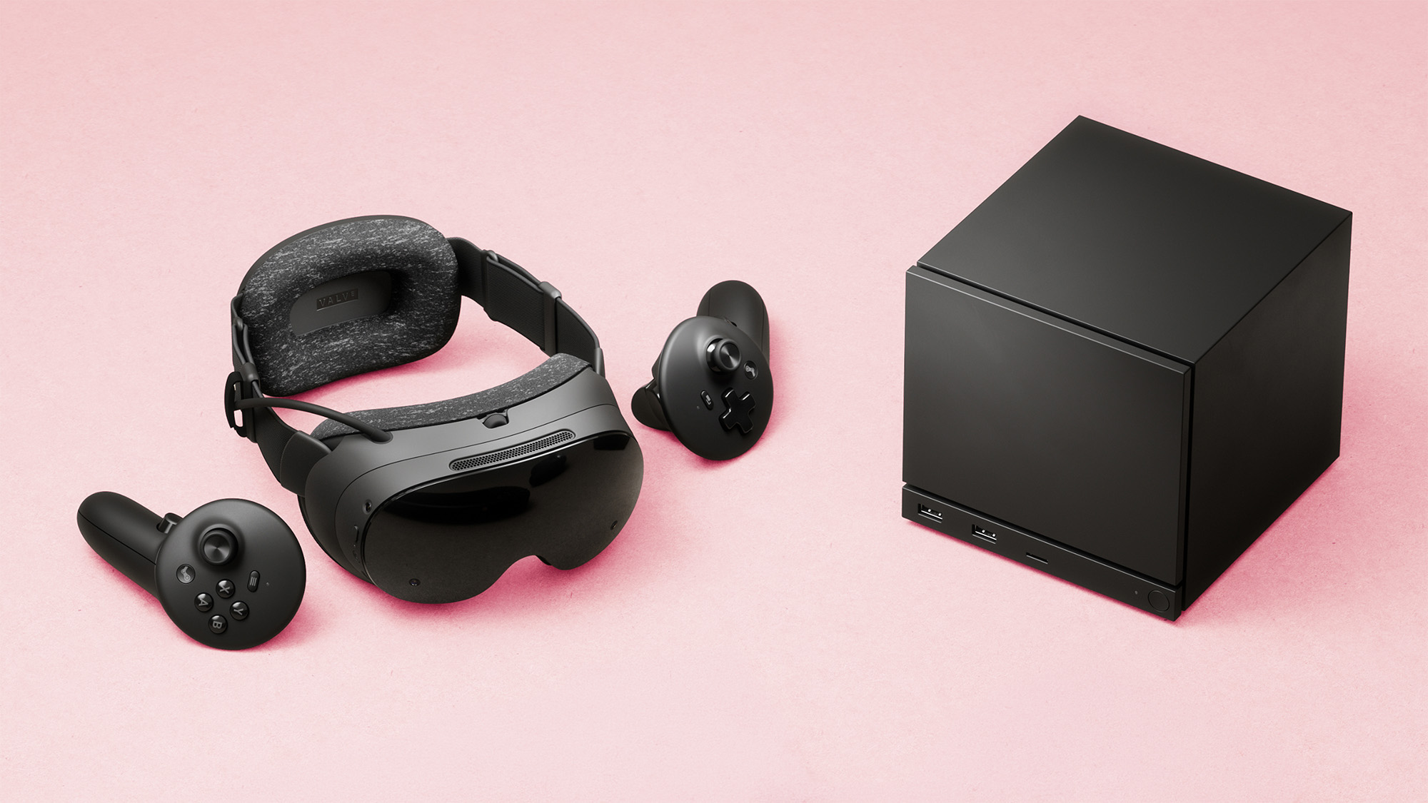 Valve Steam Frame VR headset and Steam Machine mini gaming PC on a faded magenta background