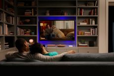 Couple watching a movie streamed over Wi-Fi on the couch