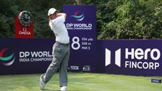 Rory McIlroy holds his finish on his tee shot on the 8th hole during a practice round at the DP World India Championship