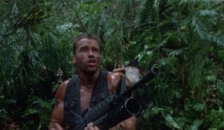 Arnold Schwarzenegger firing a big gun at the Predator