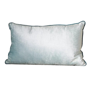 A plush rectangular pillow in ice blue with dark blue lining