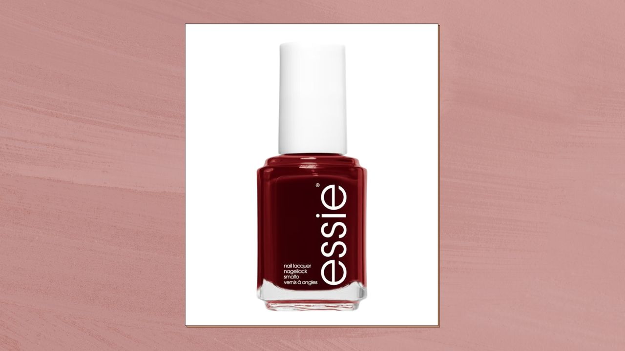 A close up of essie&#039;s nail polish in shade Bordeaux/ in a dark pink template