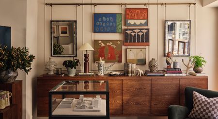 A jewelry shop designed with warm woods cabinets juxtaposed with see-through wrought iron and glass boxes, colorful ceramics and artworks, and eye-catching textiles.