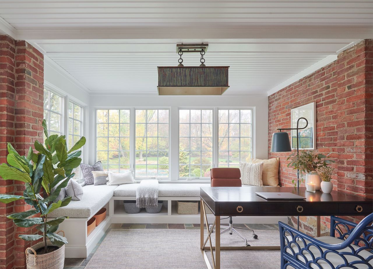 a small sunroom with built-in seating