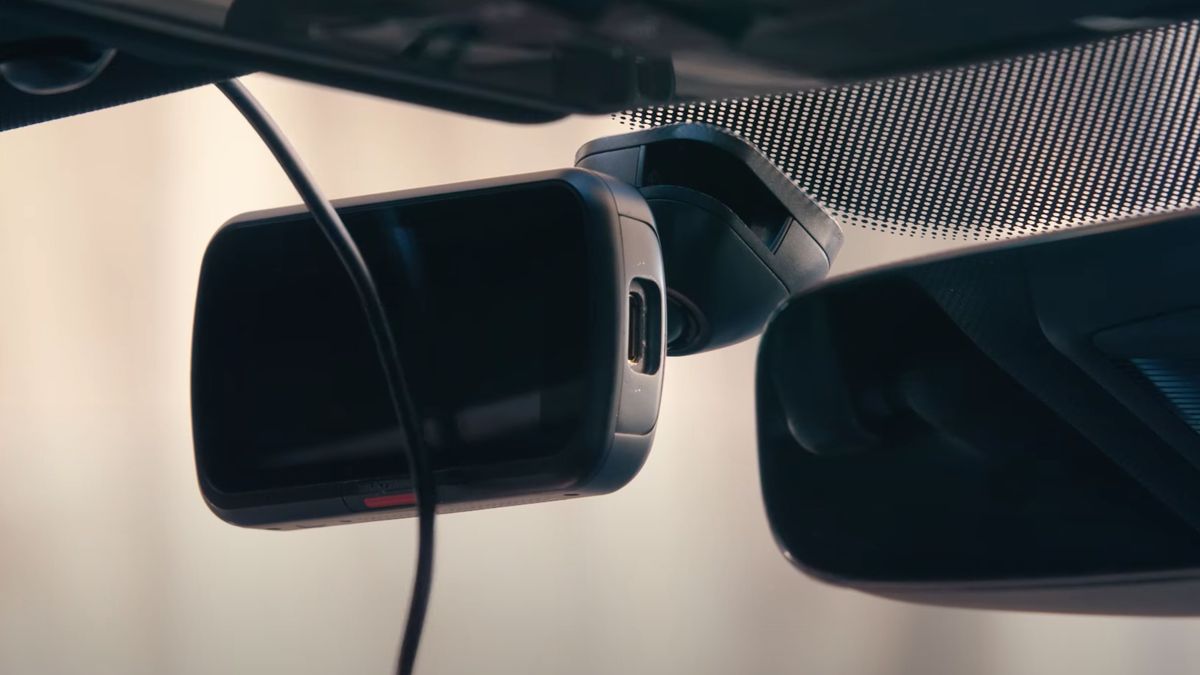 A dash cam mounted on a car windshield
