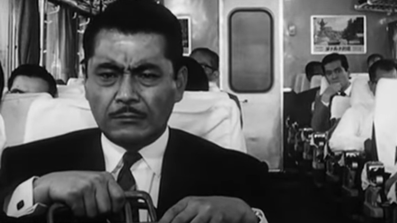 Toshiro Mifune on a train with a briefcase in High and Low
