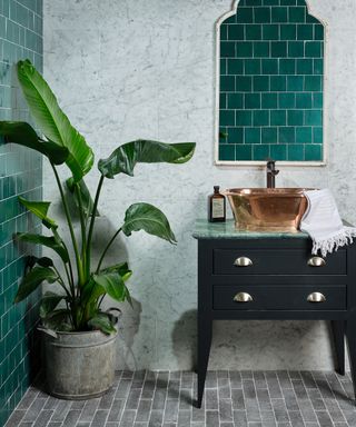 Reformed stone tiles by Ca' Pietra in teal and grey with black vanity unit