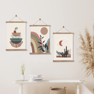 A set of three abstract geometric printed wall hangings.