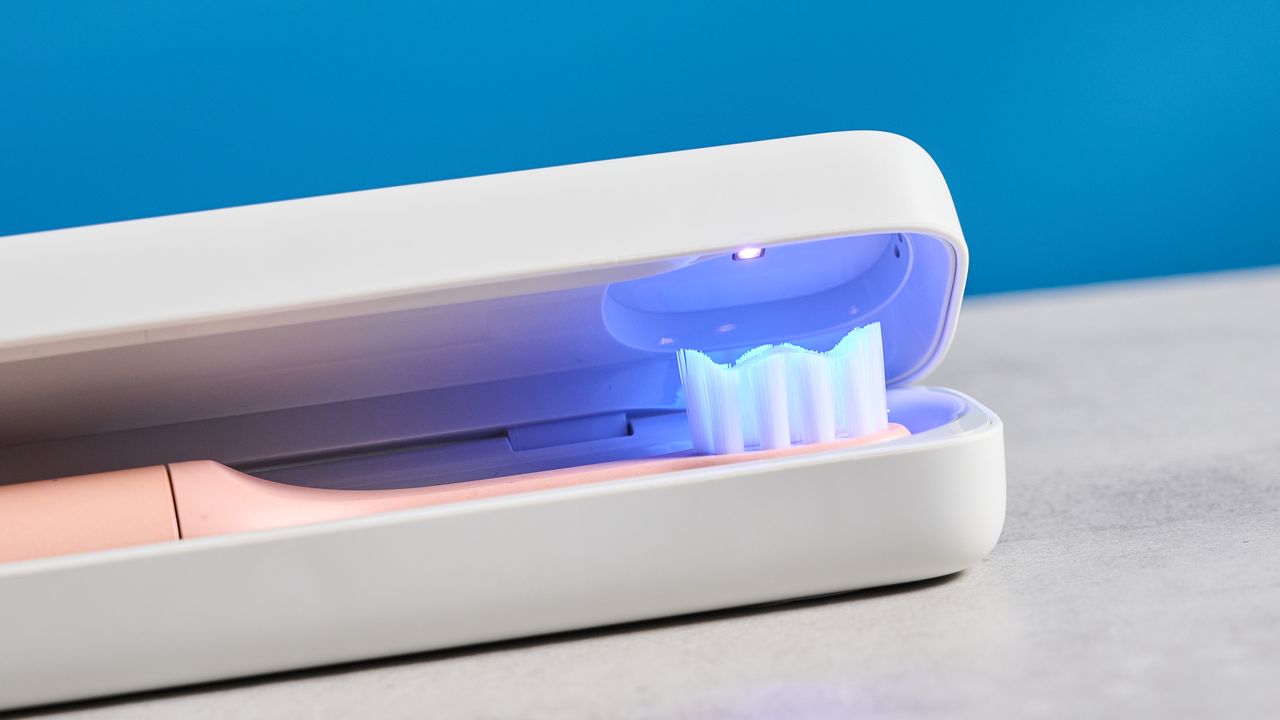 the Suri 2.0 toothbrush in sunset bloom pink colorway with a plant-based head and aluminum body, pictured with its uv cleaning travel case and the suri toothpaste