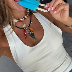 Woman in halter top and layered vacation jewelry
