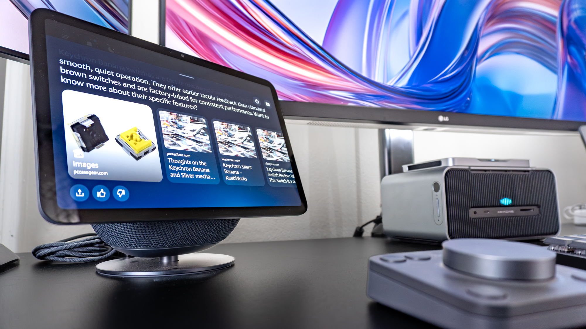 An Echo Show 11 smart display underneath a triple monitor setup on a desk