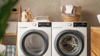 Washer and dryer deals both in white with silver drums, placed next to each other in utility room.