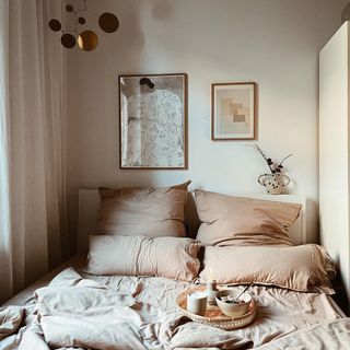 Cozy, neutral bedroom scheme with relaxed linen layers and breakfast in bed tray