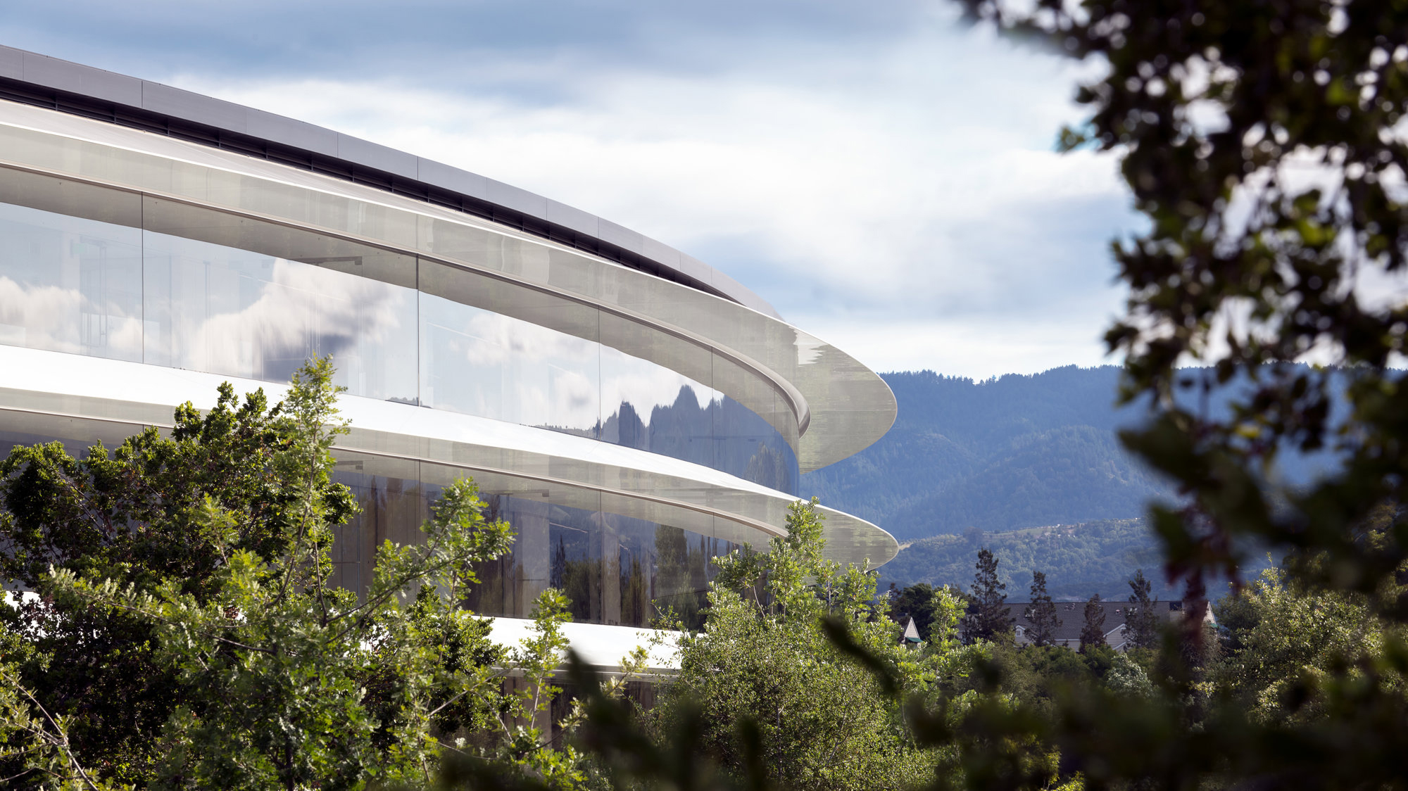 A photo of Apple Park surrounded by trees