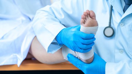 A podiatrist treating feet