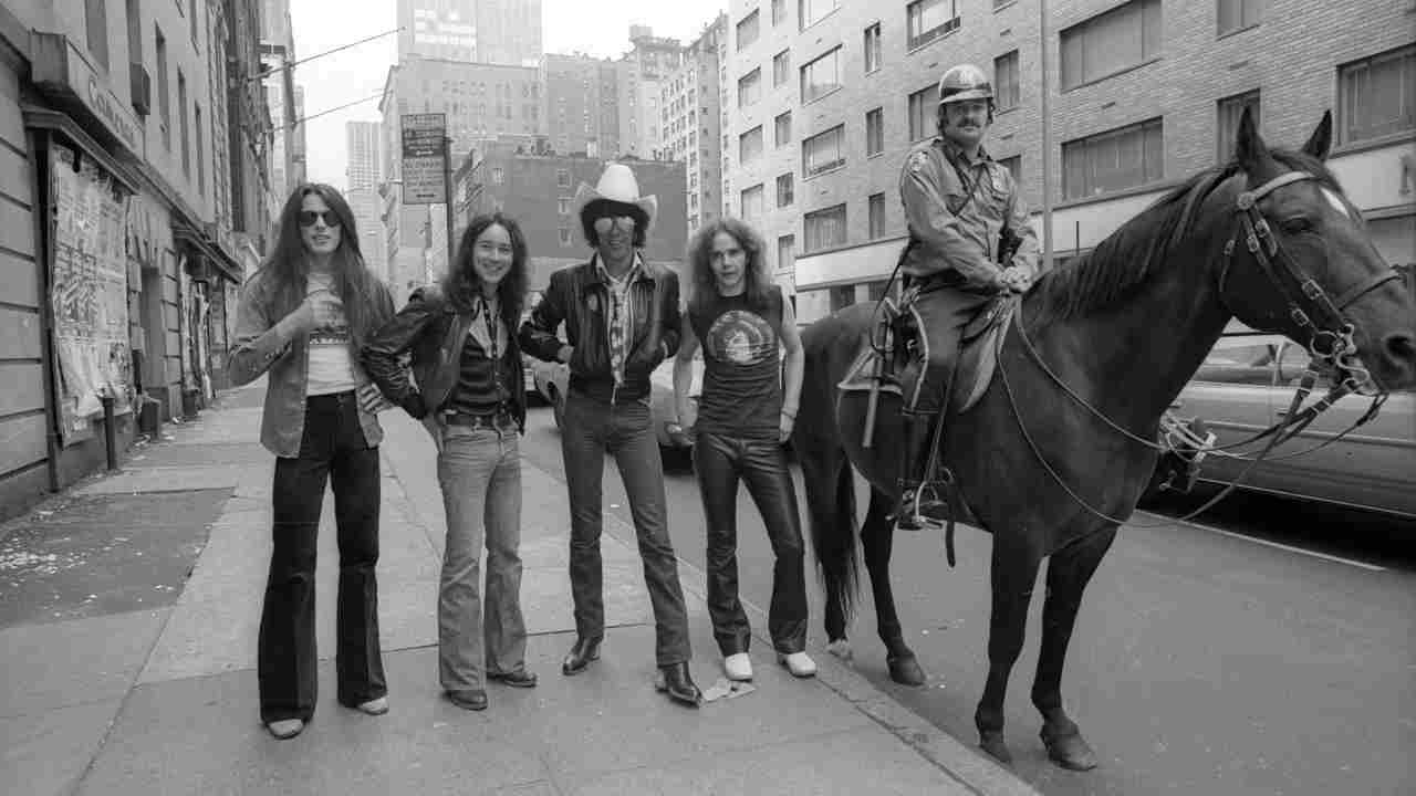 Thin Lizzy posing for a photograph next to a mounted police officer in New York