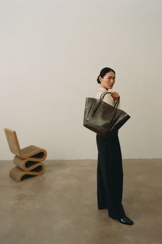 Woman in room with bag and chair