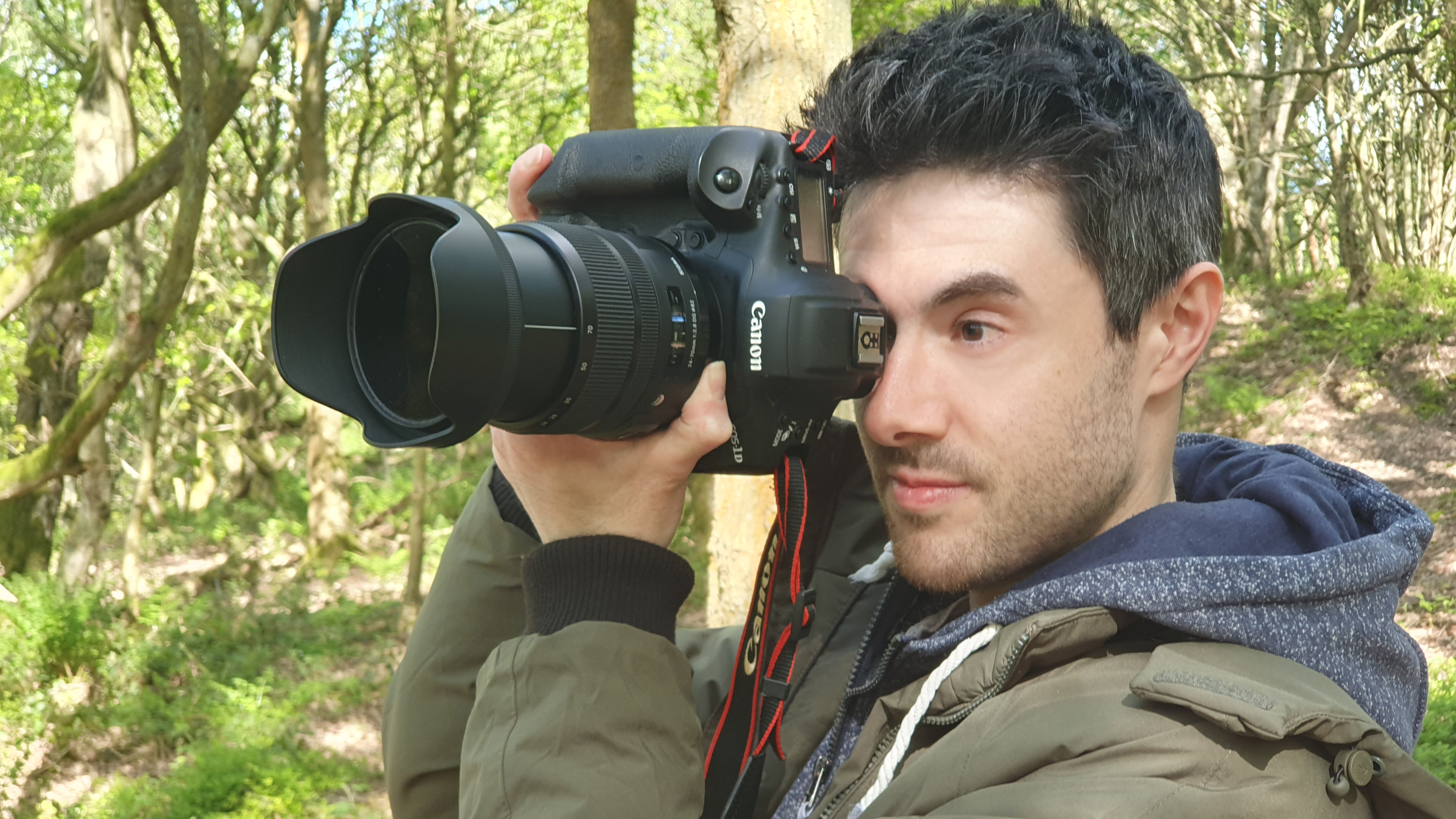 A man holding the Canon EOS 1DX Mark III camera