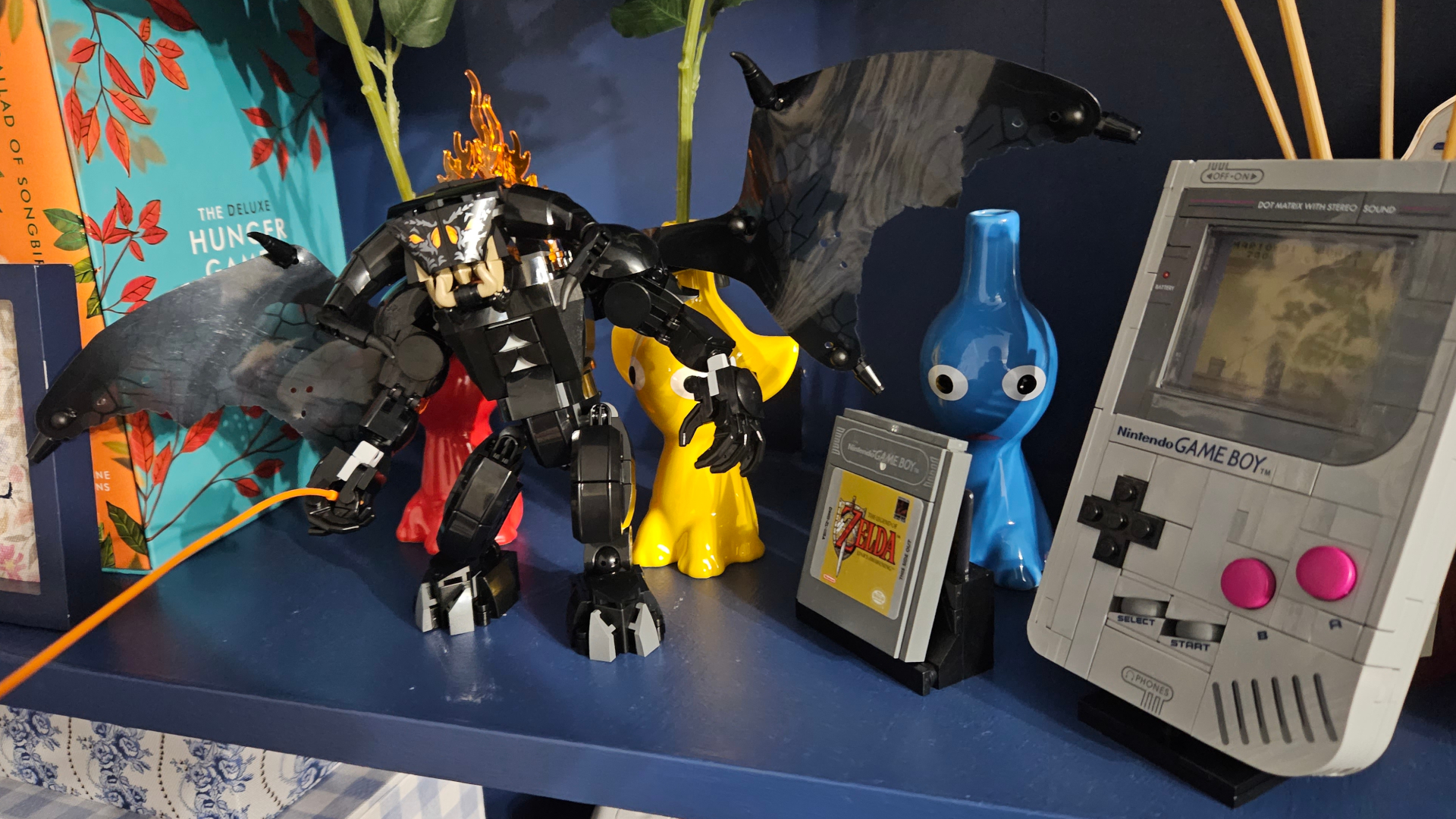 Lego Balrog Book Nook set on a shelf beside a Pikmin and Lego Game Boy