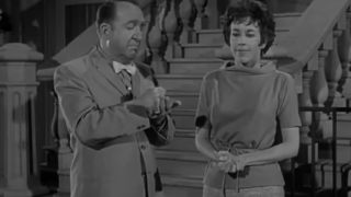 Carol Burnett and a man speak to each other in the Twilight Zone episode Cavender Is Coming