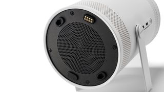 Rear of the Samsung Freestyle projector showing speaker grille and magnetic charging port