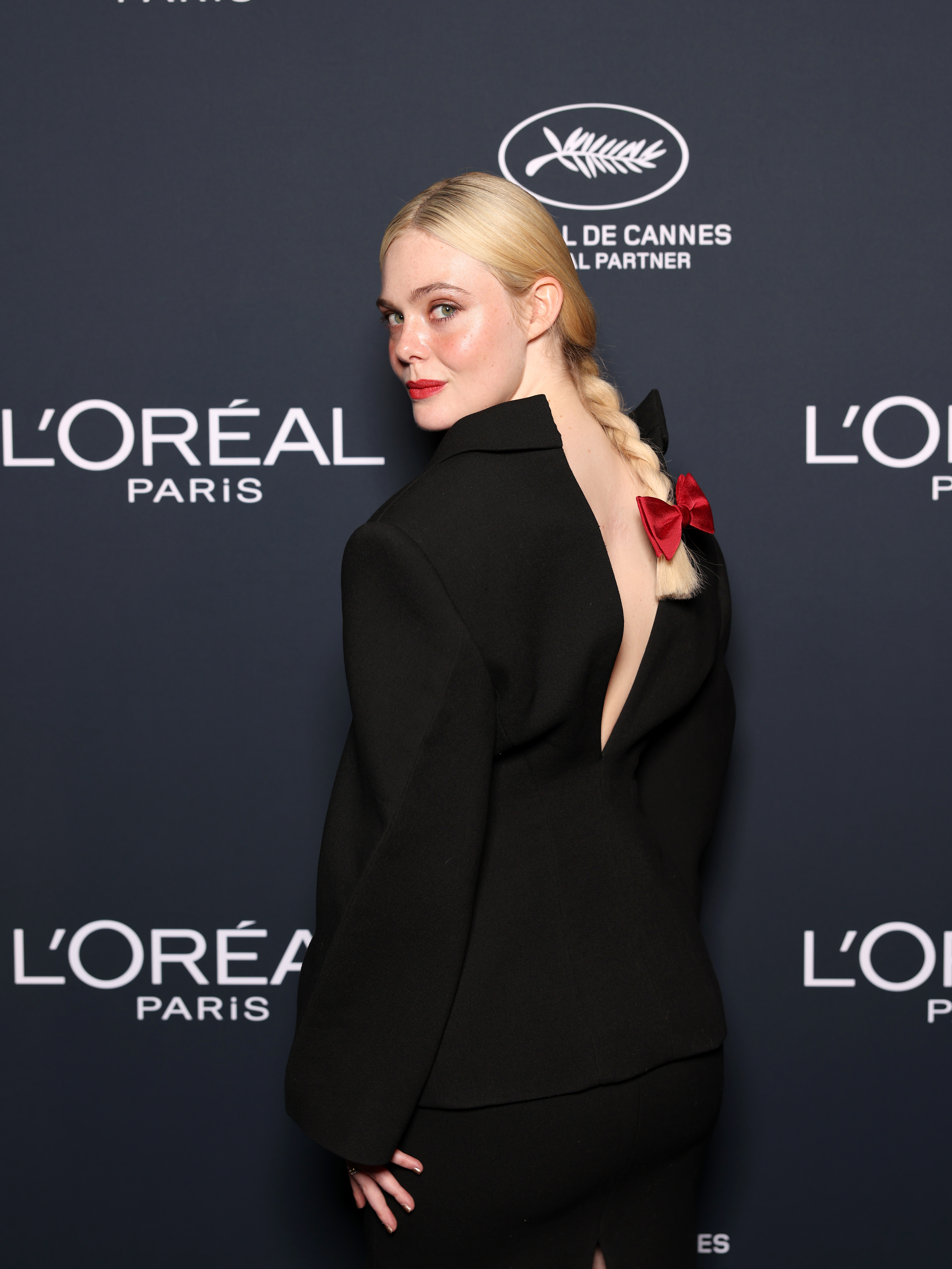 Elle Fanning wears a black Givenchy skirt suit on the red carpet for the L'Oreal Lights on Women's Worth Award at the 78th Cannes film festival on May 23, 2025