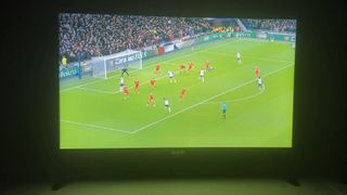 Football match displayed on RCA Roku 24-inch HD TV