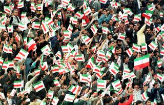 Iran fans wave flags during their World Cup qualifying match against Australia in 1997.