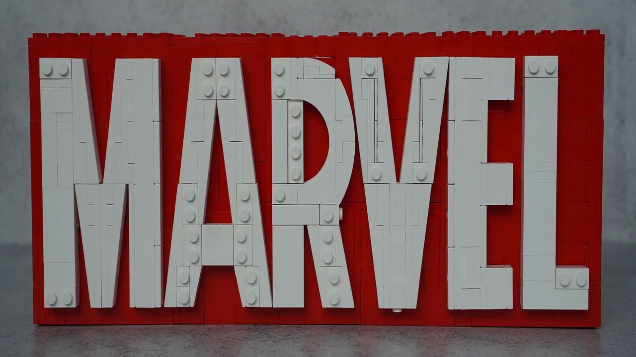 A plastic brick version of the Marvel Logo that reads "Marvel" in white capital letters on a red background, in front of a grey background