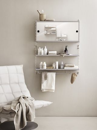 simple modern bathroom with open shelving and a mirrored cabinet