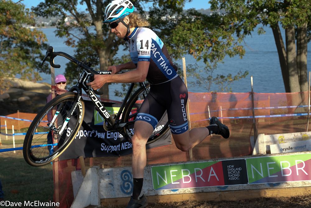 Scott Smith (JAM/NCC) sprinting over some barriers during the first lap