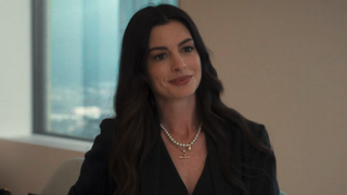 Anne Hathaway smiling in The Devil Wears Prada 2