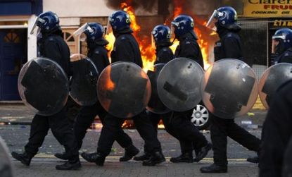 Riot police during the height of London's upheaval: Britain's poor economy and unemployment rates are similar to ours, which leads some to worry that an uprising is nye.