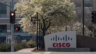 A Cisco sign on a street corner next to a red traffic light