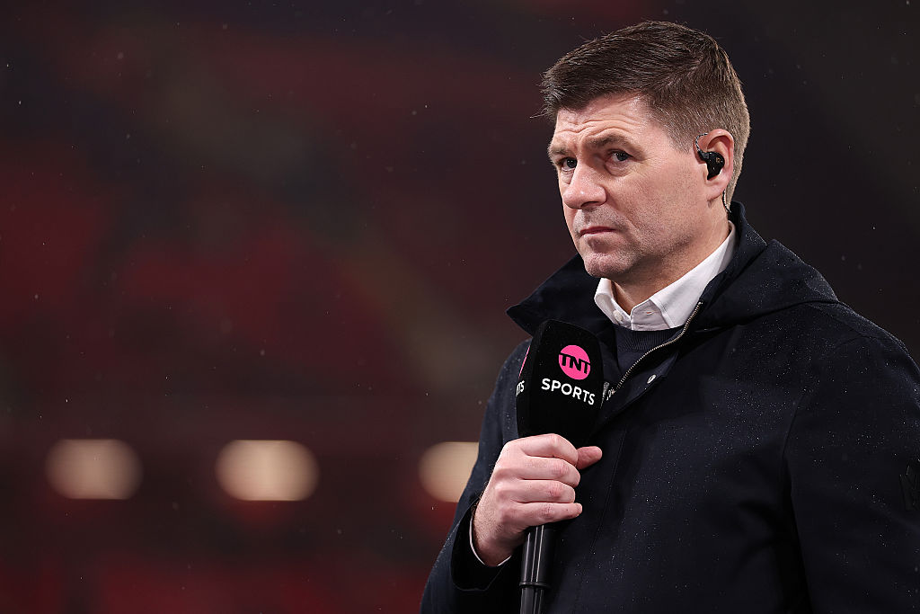TNT Sports pundit Steven Gerrard holding a mic.