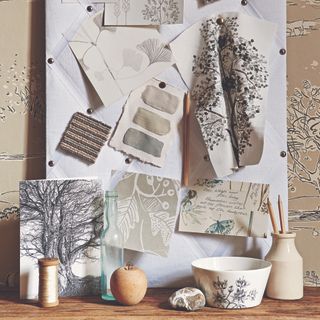 Neutral mood board on pinboard with swatches of materials.