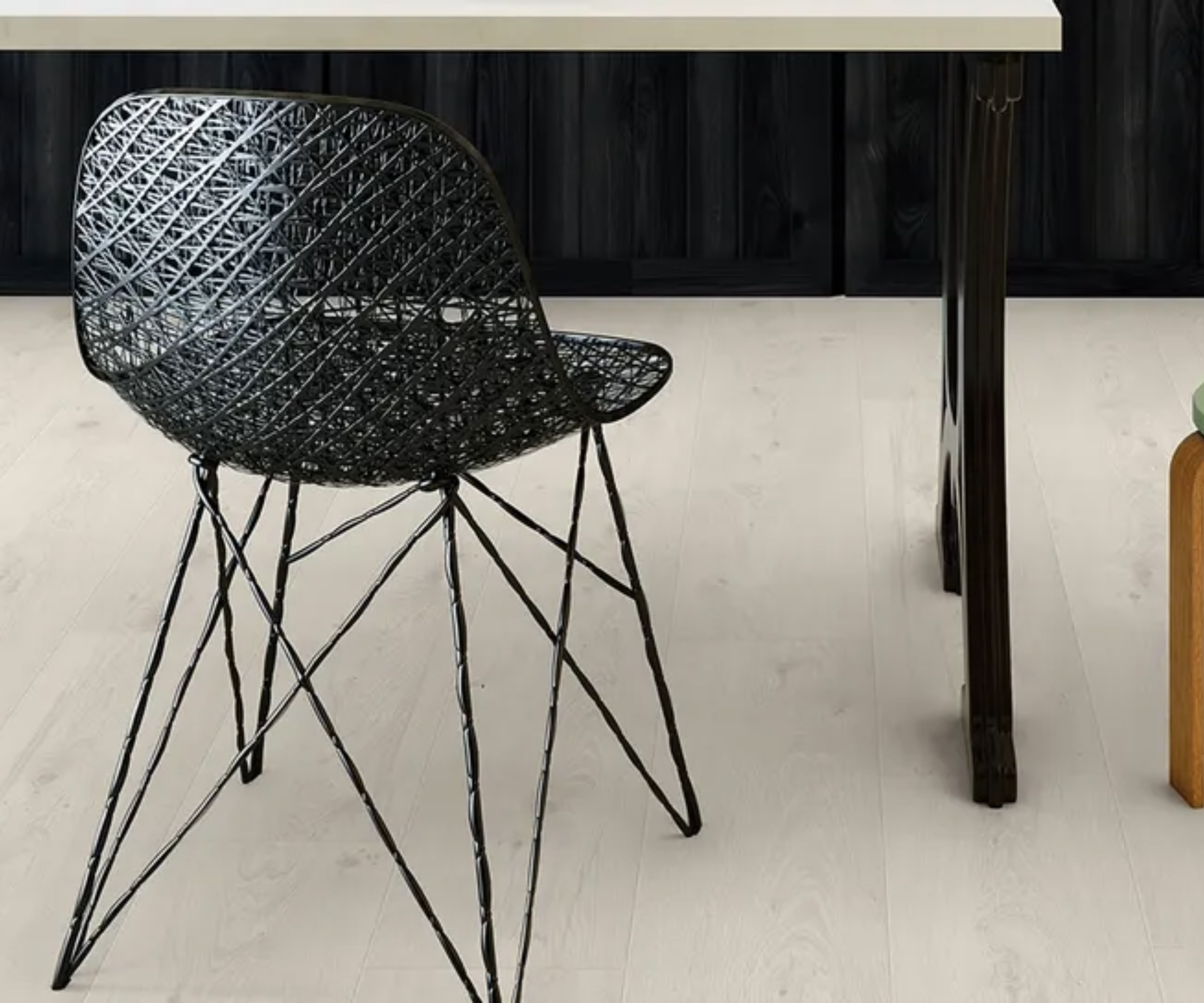 Pale laminate flooring with a black chair