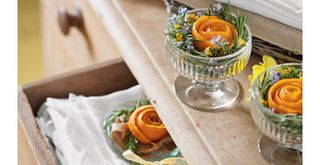 Small glass bowls with orange peel and lavender to suggest how to make your house smell good with DIY scent centerpieces