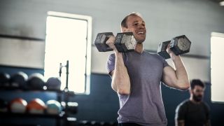 Man with dumbbells in front rack position
