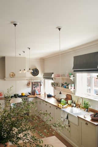Pale pink kitchen with shaker cabinets by deVOL