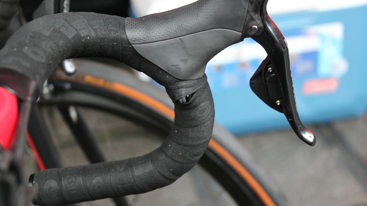 Some mechanics make a small cut in the tape, others just wrap tightly around the shifter